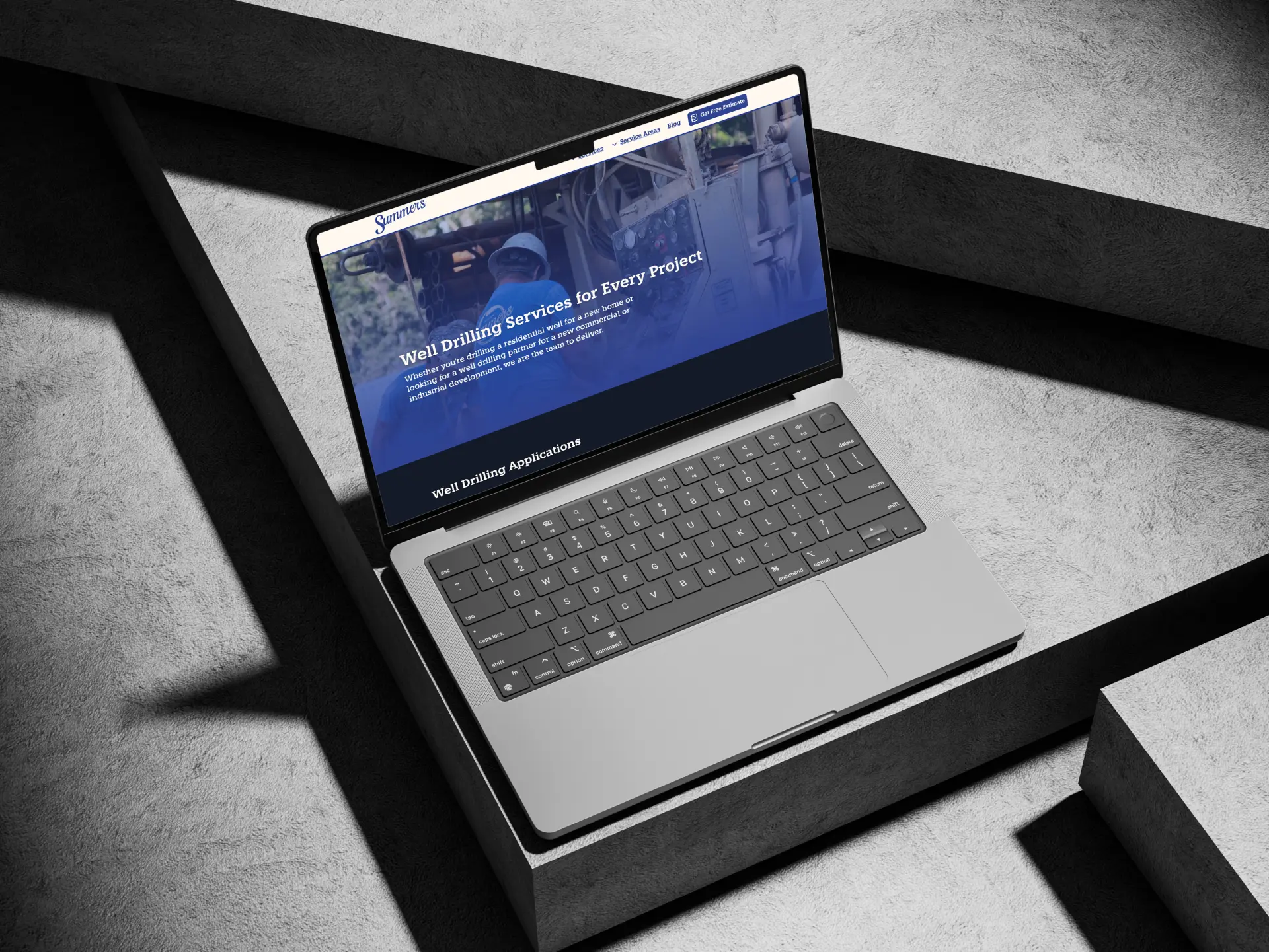 A MacBook open to the Summers Well Drilling website