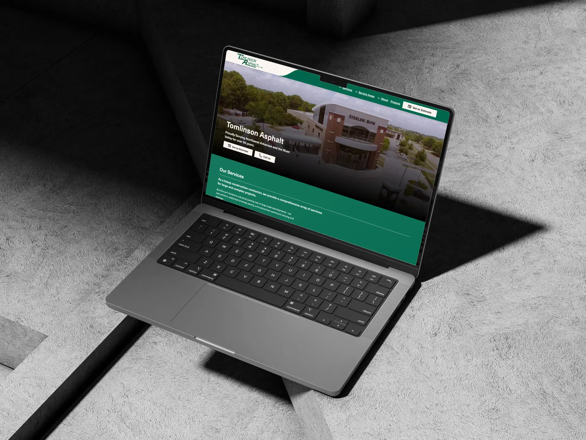 A MacBook open to the Tomlinson Asphalt website